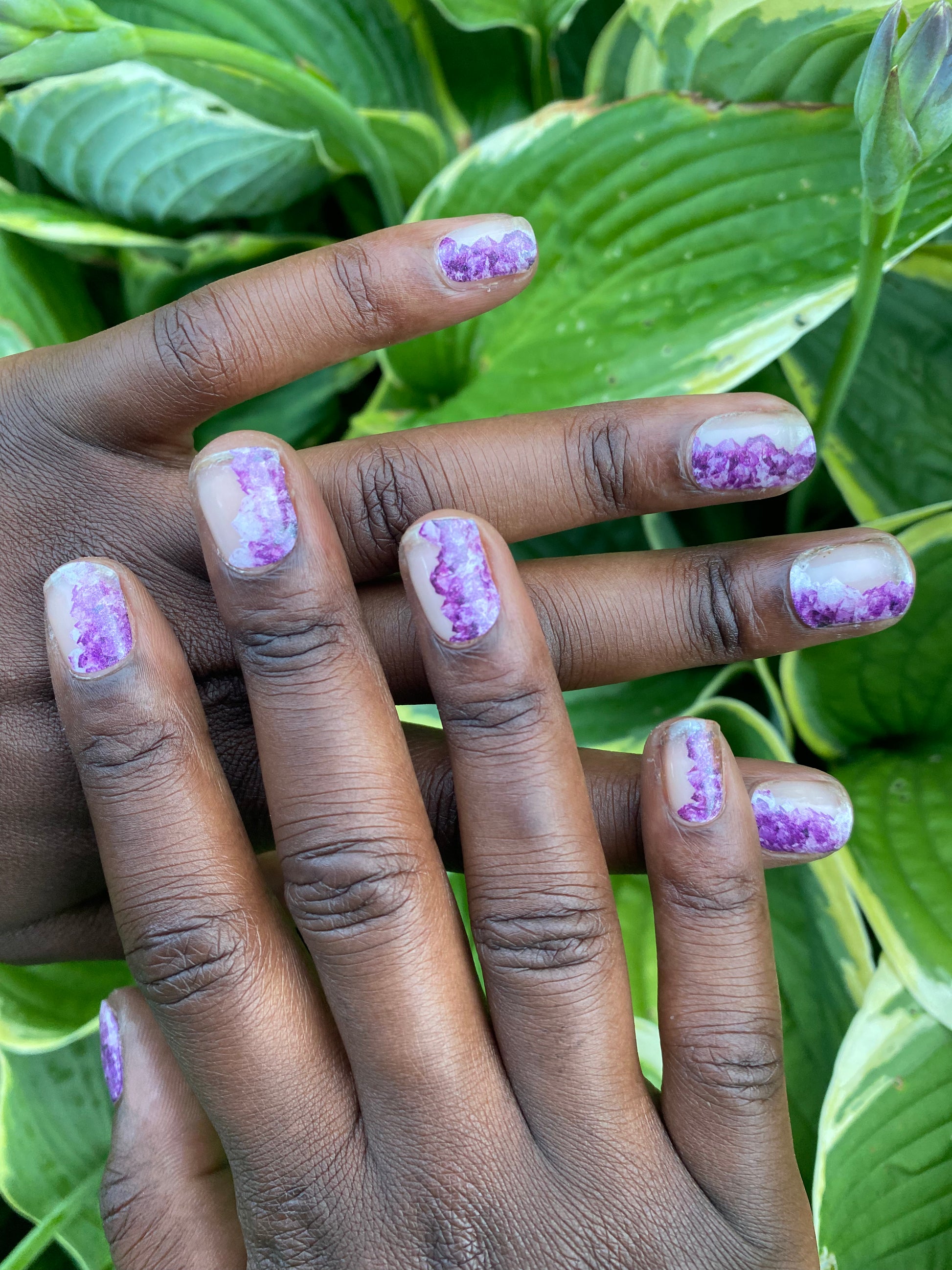 Brown hands with nail wraps